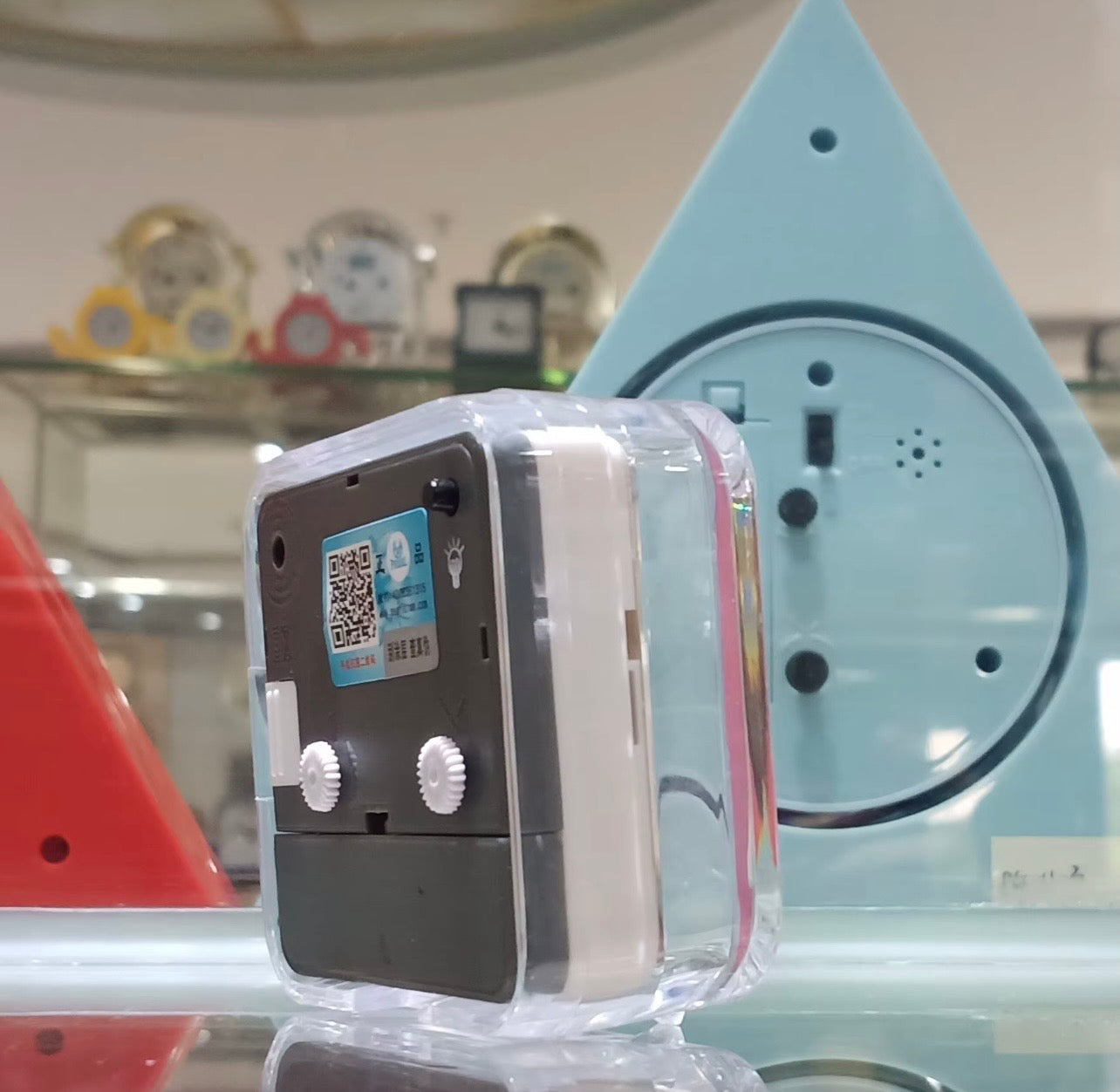 Transparent alarm clock internals with gray mechanism in open casing