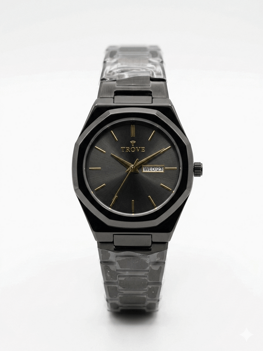 Waterproof Trove black wristwatch with dark face, gold markers, clear link band.