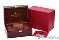 Original Patek Philippe burgundy wooden watch box open with brown leather cushion, red outer box, yellow booklet, guarantee card and red shopping bag