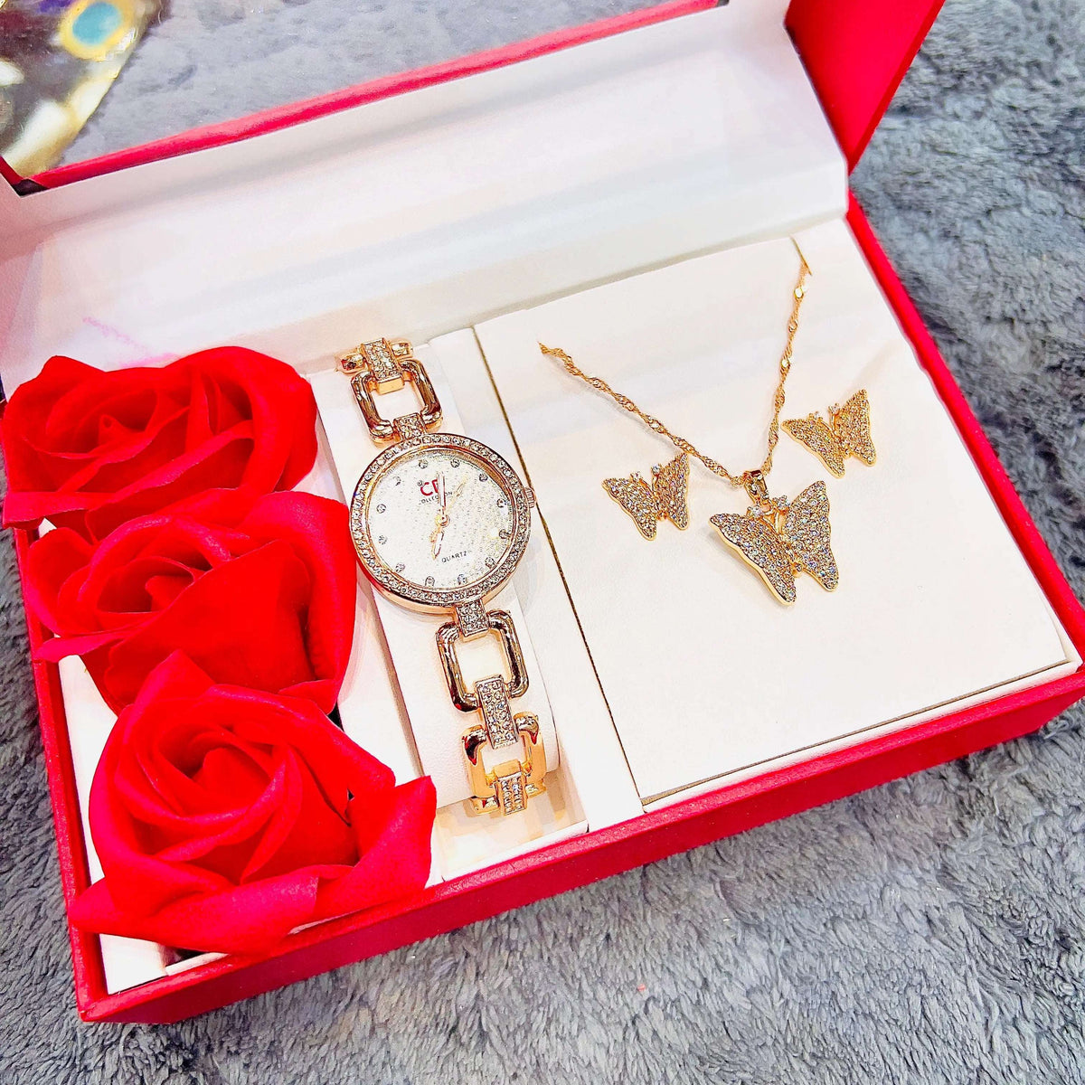 Rose gold-tone watch and necklace set with star/butterfly charms, bracelet, and stud earrings