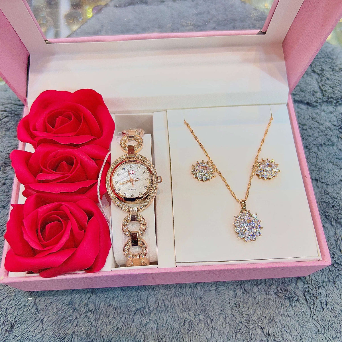 Rose gold-tone watch set with charm necklace, heart pendants, and matching stud earrings