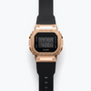 Casio G-Shock digital watch with rose-gold bezel, black strap, and LCD display