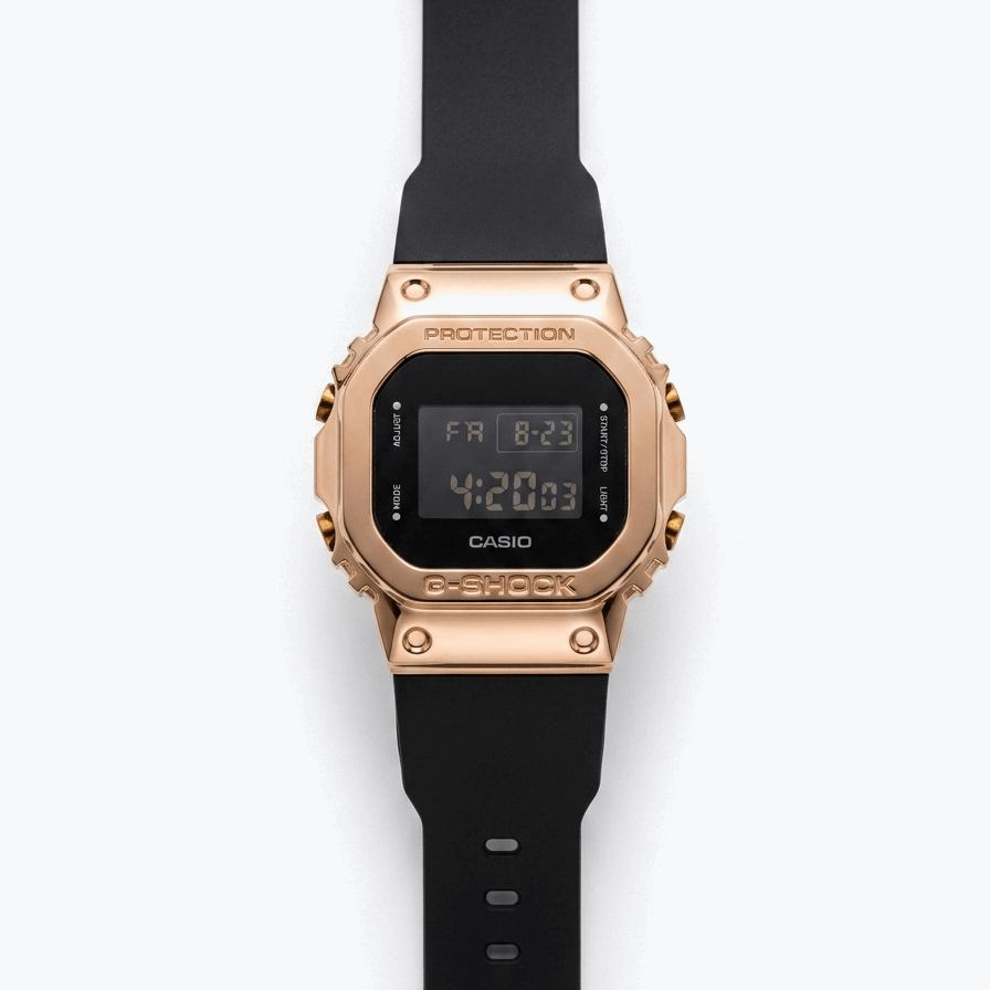 Casio G-Shock digital watch with rose-gold bezel, black strap, and LCD display