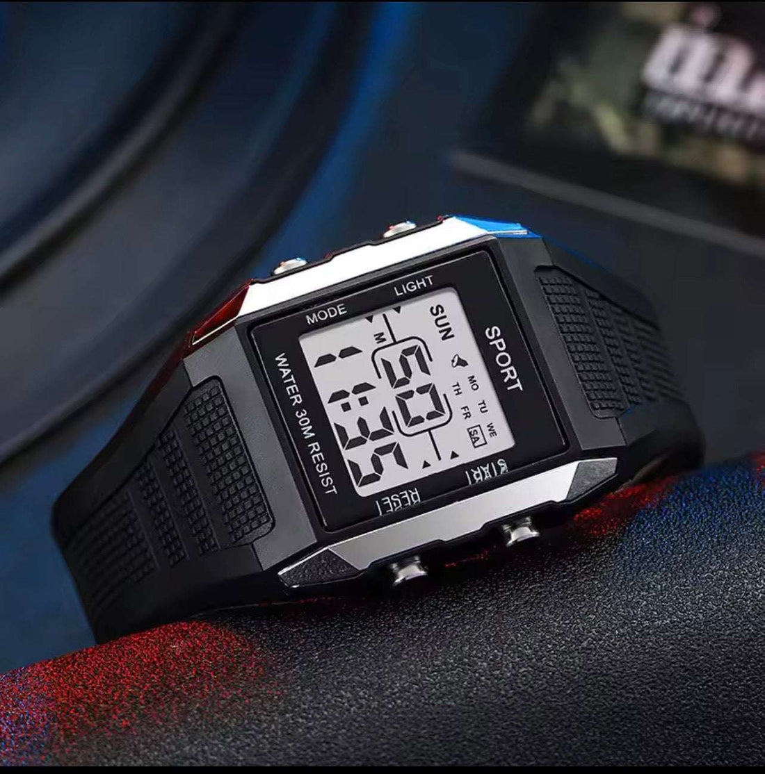 Blue-toned square sport digital watch with LCD display and black textured strap