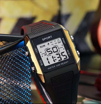 Square digital sport watch with black band, gold/silver case, LCD showing time