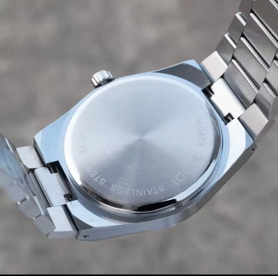 Stainless steel watch case back with engraved text and metal bracelet