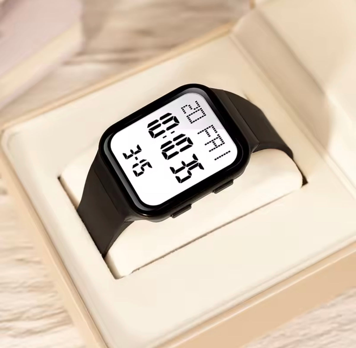 Black silicone square digital LED watch showing large white time and date digits