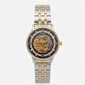 Rolex two-tone skeleton watch with a blue dial, gold-tone inner dial and crown, and a silver and gold-tone stainless steel link bracelet, shown on a light gray background.
