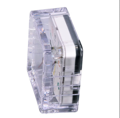 Clear compact alarm clock body, angled side view with transparent casing