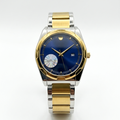 Two-tone stainless steel men's watch with blue dial, gold hands, and link bracelet