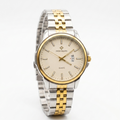 Patek Philppe round two-tone men's watch with gold bezel, date window, and silver strap