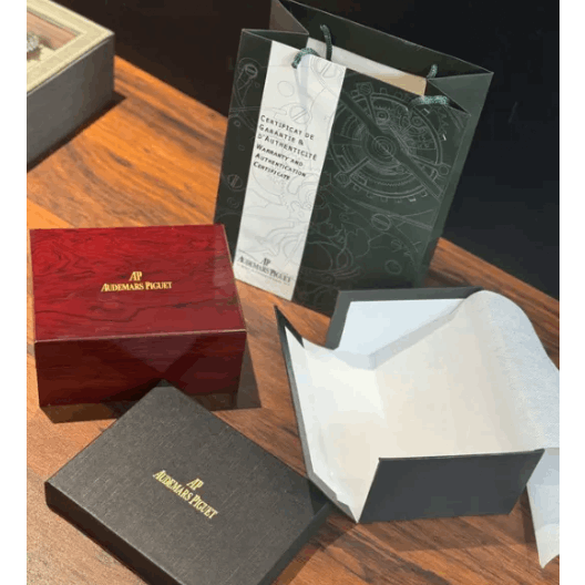 Watch box set with certificate, dark inner tray, and branded red outer box