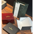Original Audemars Piguet watch box set with red lacquered wooden box, dark grey document box, warranty certificate and dark green AP shopping bag