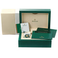 Original Rolex green watch box open showing cream interior cushion with outer white box