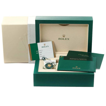 Rolex watch box set with green case, papers, and pouch