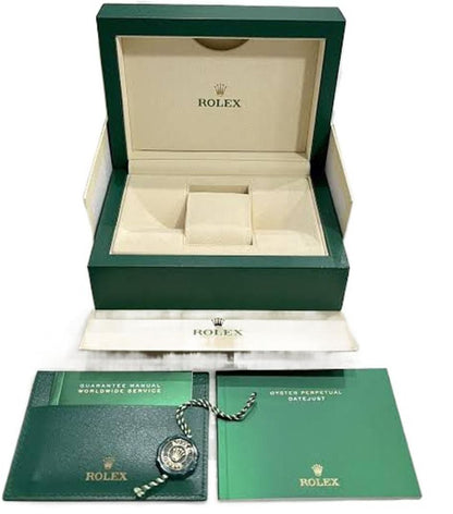 Rolex watch box open with beige insert, papers, chain and two document cards