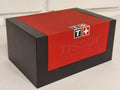 Original Tissot watch box open showing white cushion interior with red sliding lid and Tissot T-logo