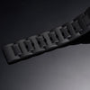 Black rubber watch strap close-up with textured segments and raised lug pattern
