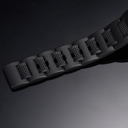 Black rubber watch strap close-up with textured segments and raised lug pattern