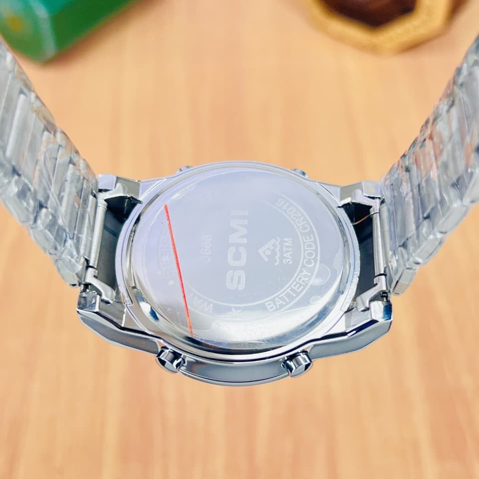 Digital alarm men's watch, silver metal band, rear case and round back visible.