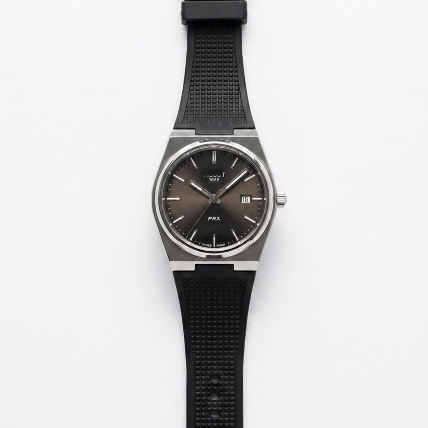 Men's silicone strap watch with black dial and black rubber band, round steel case.