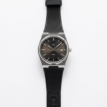 Men's silicone strap watch with black dial and black rubber band, round steel case.