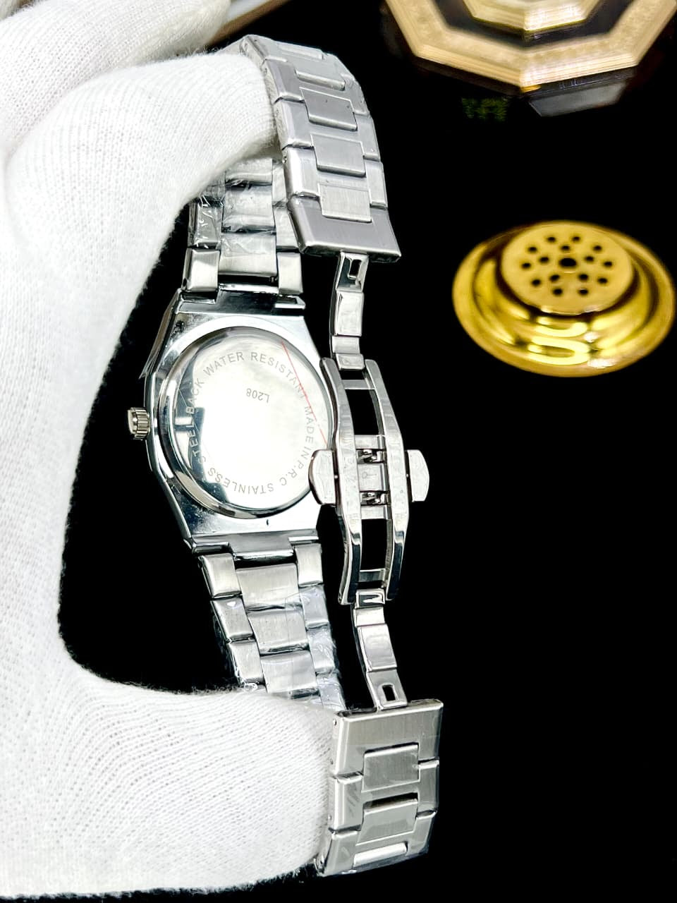 Men's black stainless steel wristwatch with metal bracelet on wrist