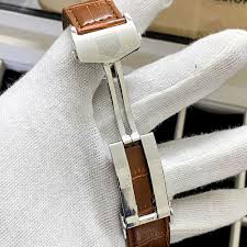 Leather strap watch close-up with white band and silver clasp